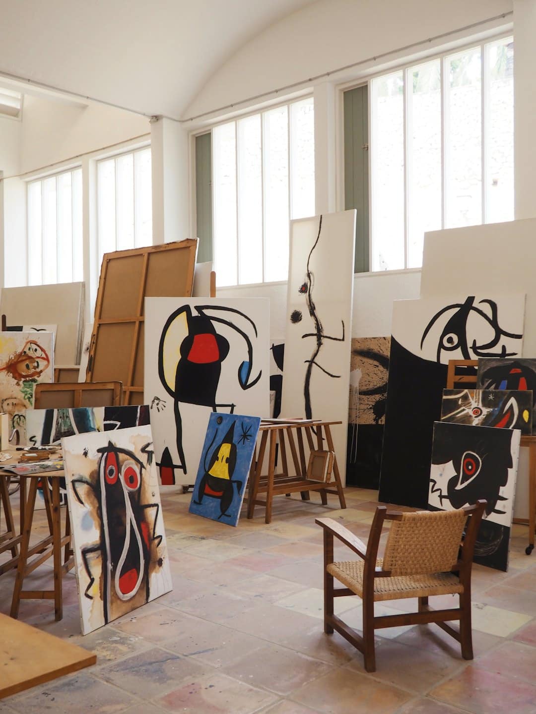 Quadri astratti esposti in un luminoso studio d'artista.